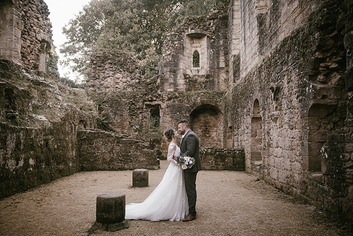 bride and groom at the castle ruins near the engine shed wetherby